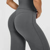 A model wearing high waisted wide leg yoga pants in a solid gray color.