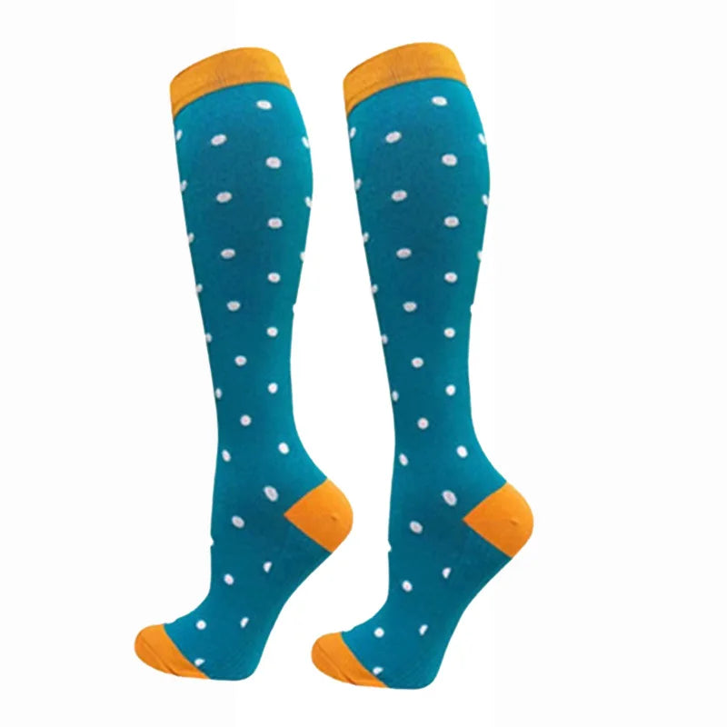 A pair of teal compression elastic socks with orange trim and white polka dots.