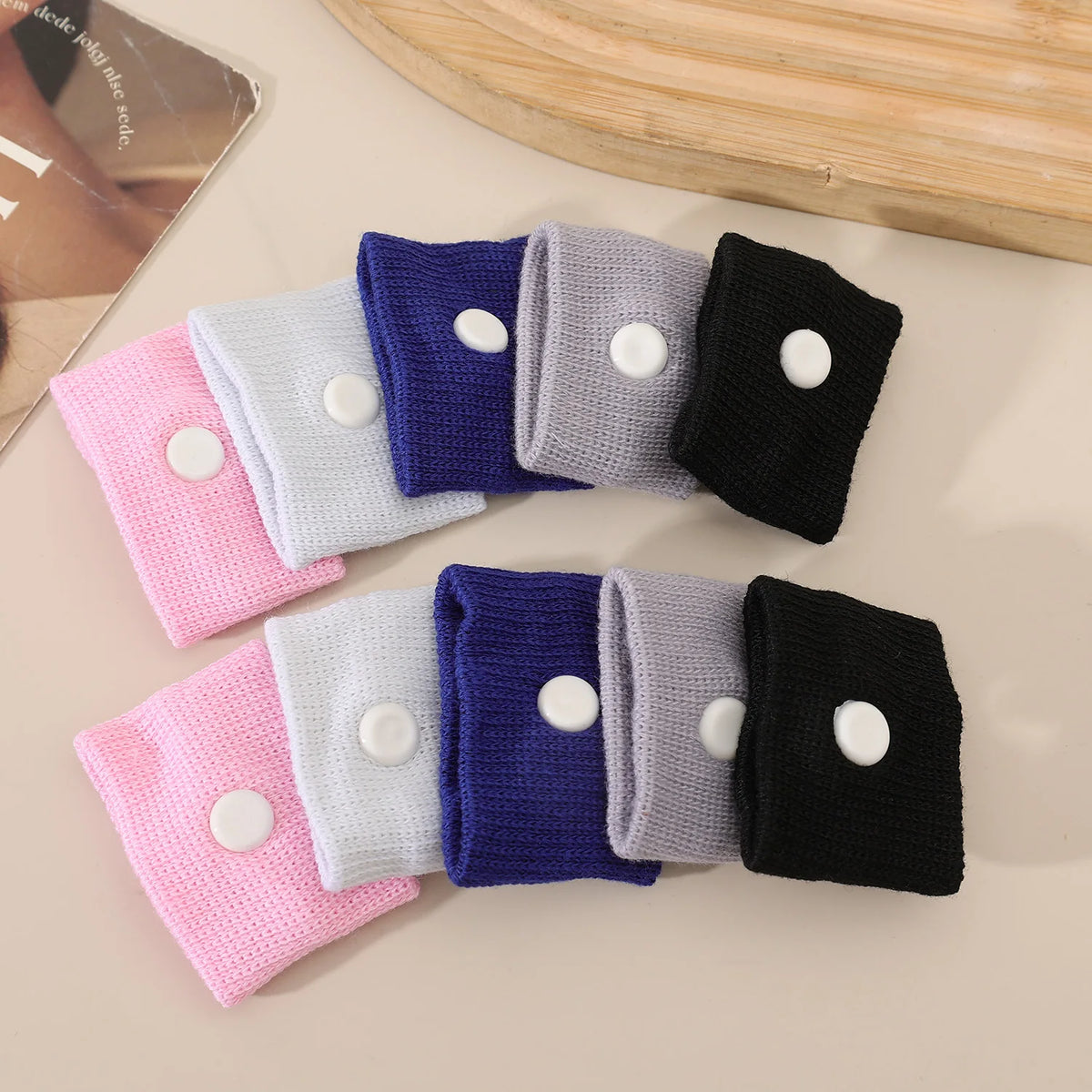 A collection of purple, blue, gray, and black anti-nausea wristbands arranged on a light surface.