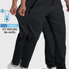 A person wearing black breathable men's casual jogger pants with a drawstring and white sneakers.