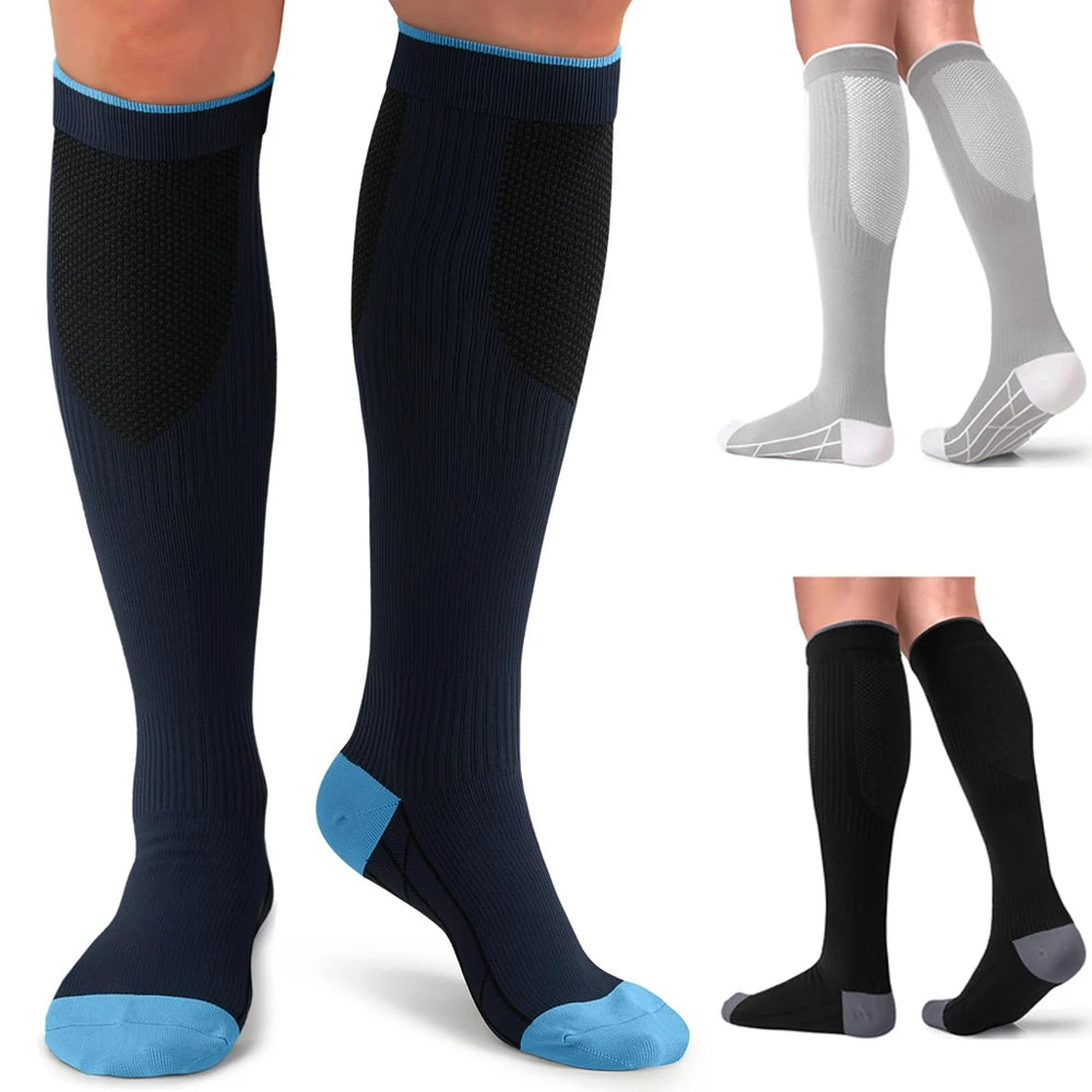 A set of compression socks in navy blue and black with light gray accents shown on a foot.