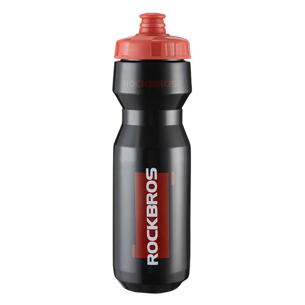 A black sports water bottle with an orange cap and red lettering on the body.