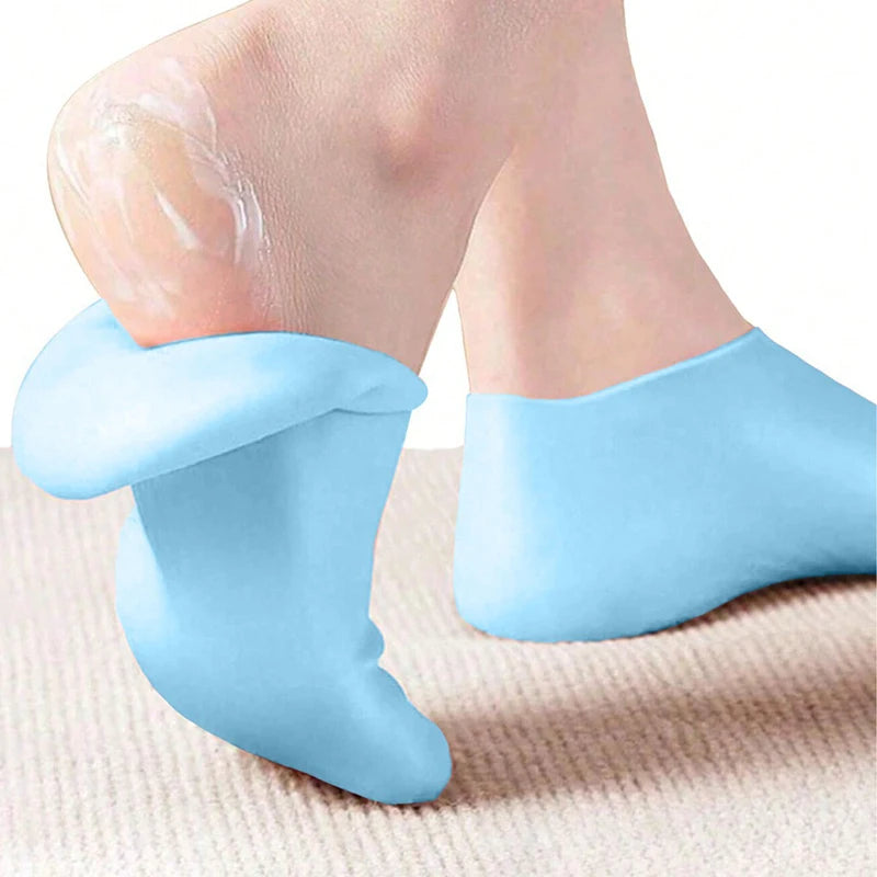 Light blue silicone moisturizing socks being worn on a foot.