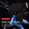 Black high-density sports gloves being worn on a hand holding a bicycle handlebar.