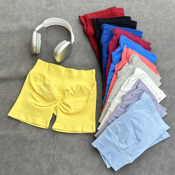A collection of high-waisted seamless yoga fitness shorts in various colors, including yellow, red, black, blue, and pink.