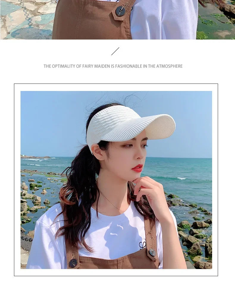 A woman wearing a white breathable anti-UV adjustable sun hat and a brown vest stands by the sea.