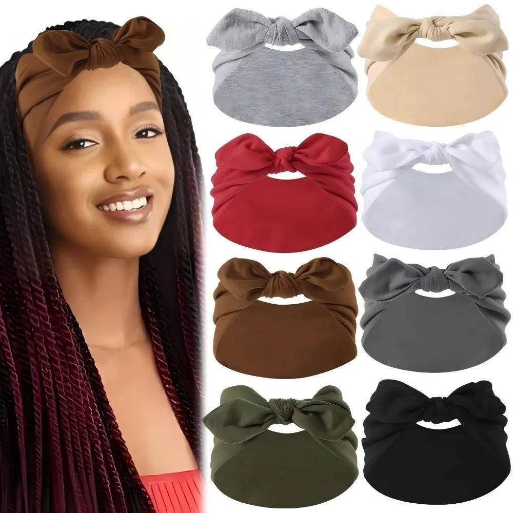A woman models a brown bohemian bunny ear headband with long dark hair.