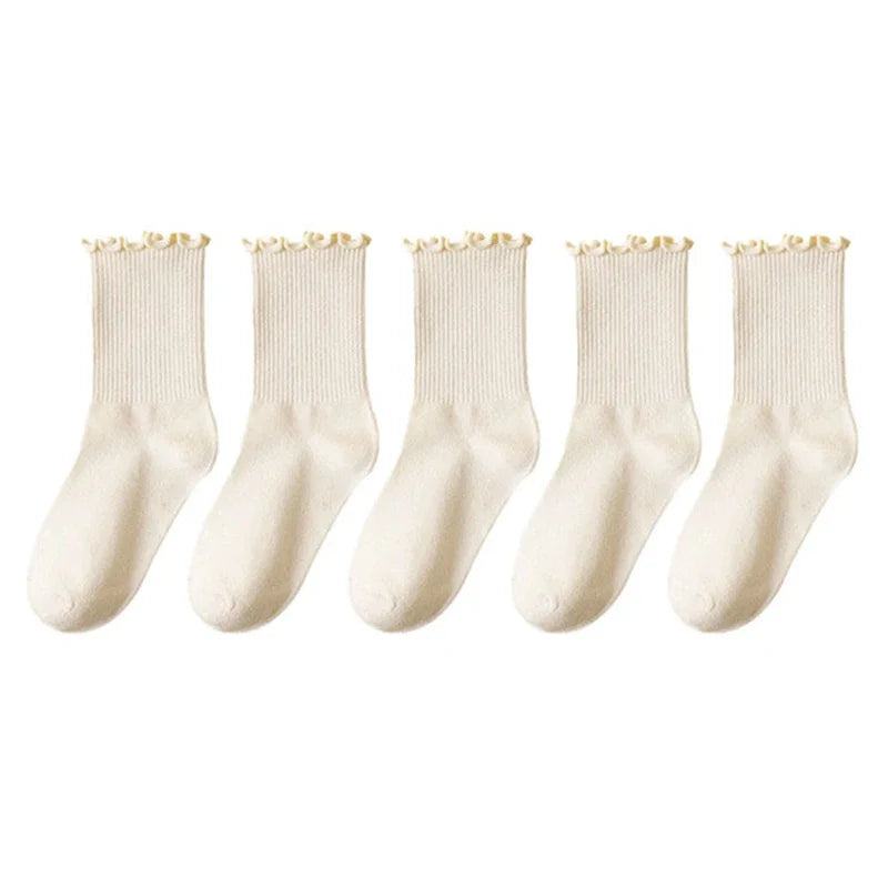 A pack of three white cotton ankle socks with ruffled edges.