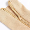 Close-up of beige high elasticity compression socks with a gold zipper detail.
