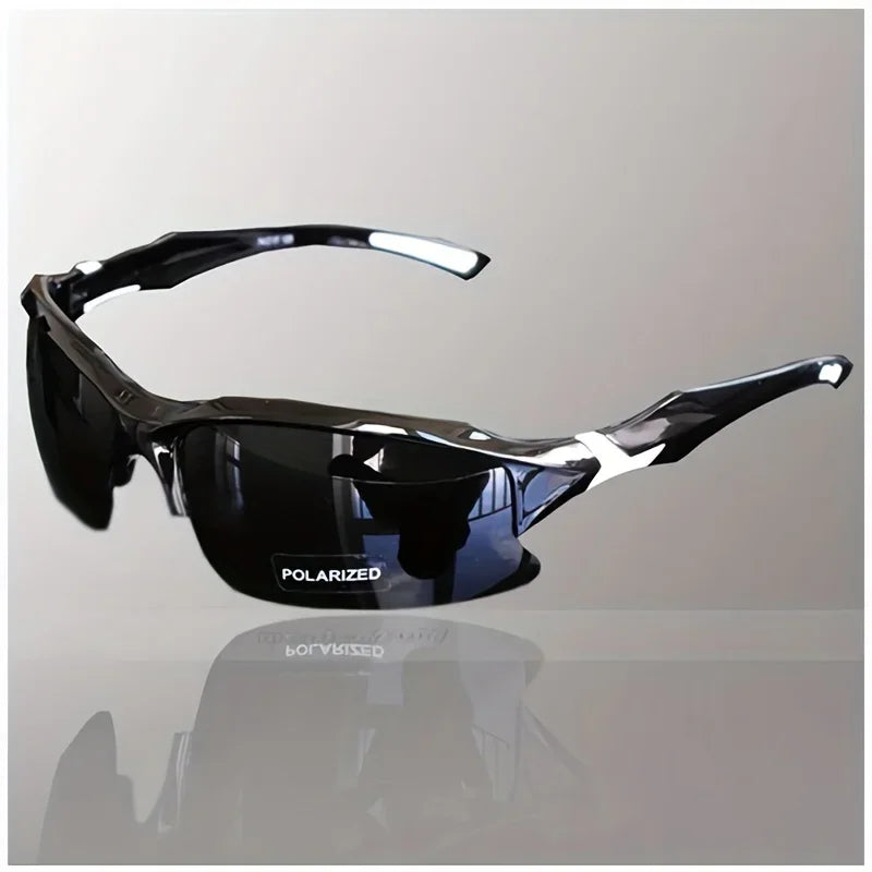 A pair of black polarized sport sunglasses resting on a reflective surface.