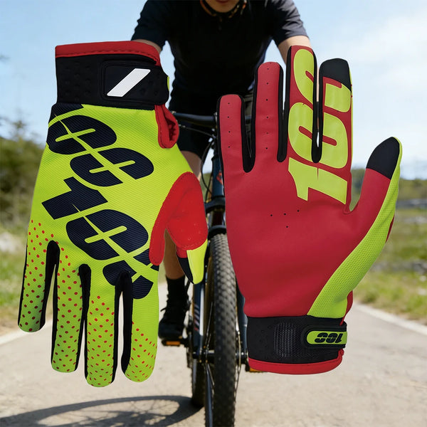 A close-up of a hand wearing bright neon yellow and red cycling gloves while riding a bicycle.