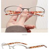 A pair of silver metal-framed oval eyeglasses with a leopard print tortoiseshell temple.