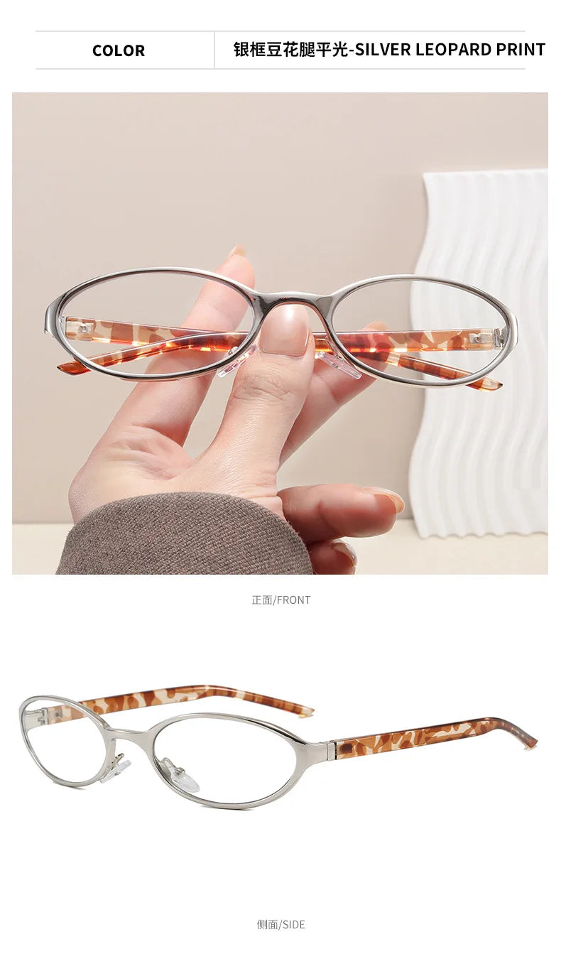 A pair of silver metal-framed oval eyeglasses with a leopard print tortoiseshell temple.