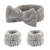 A set of gray microfiber spa headband and wristband featuring a fluffy texture.