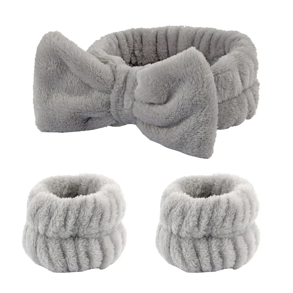 A set of gray microfiber spa headband and wristband featuring a fluffy texture.