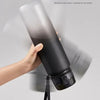 A hand is holding a black sports water bottle, demonstrating its leak-proof feature.
