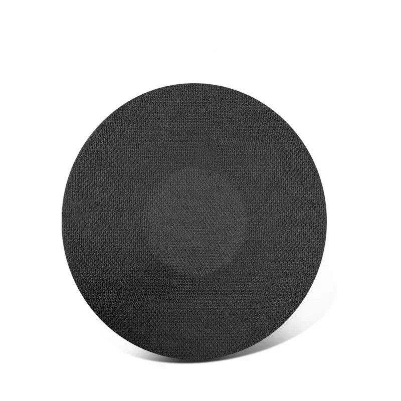 A round, black adhesive patch used for sensor fixing.