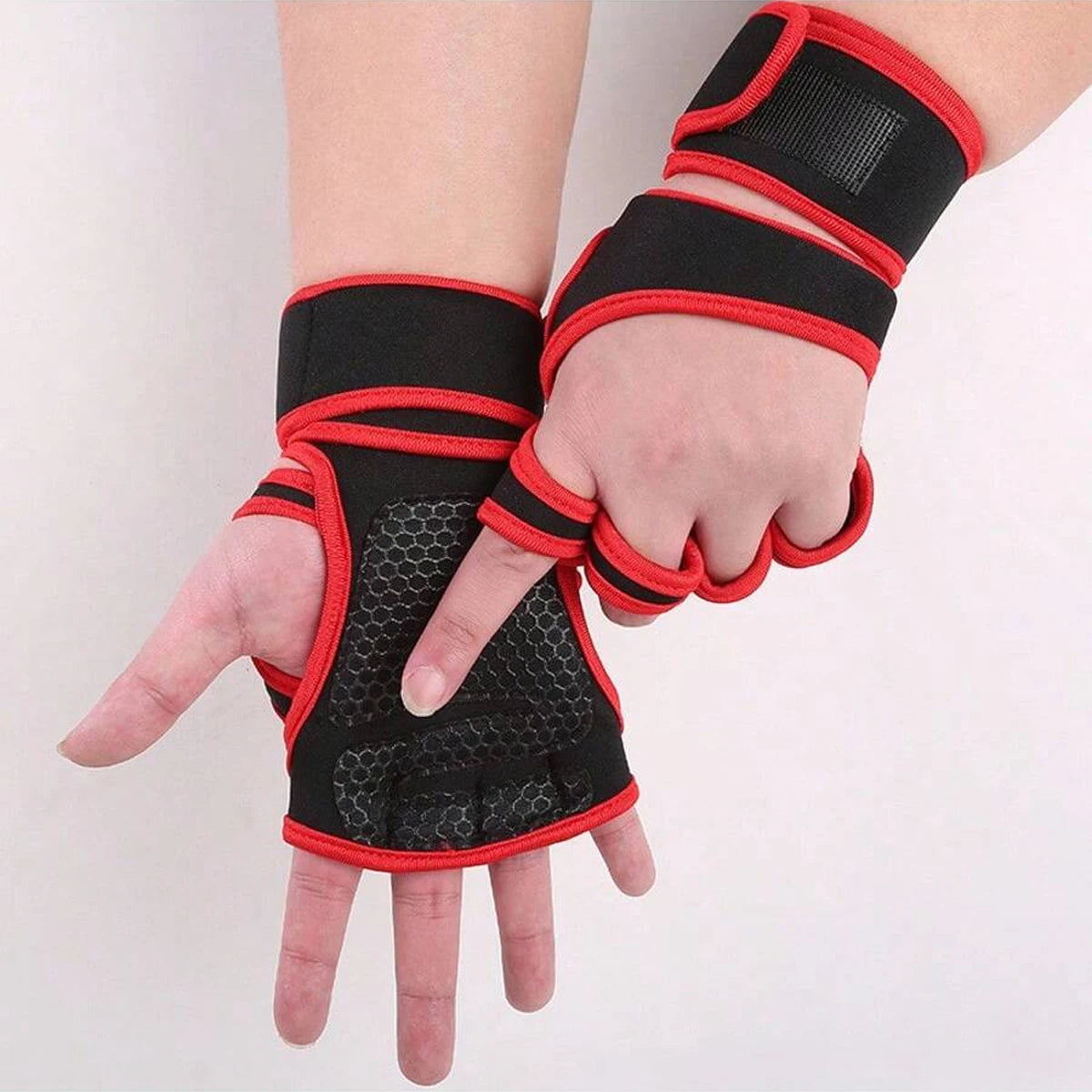 Black and red gym lifting workout gloves protecting the hand and wrist.