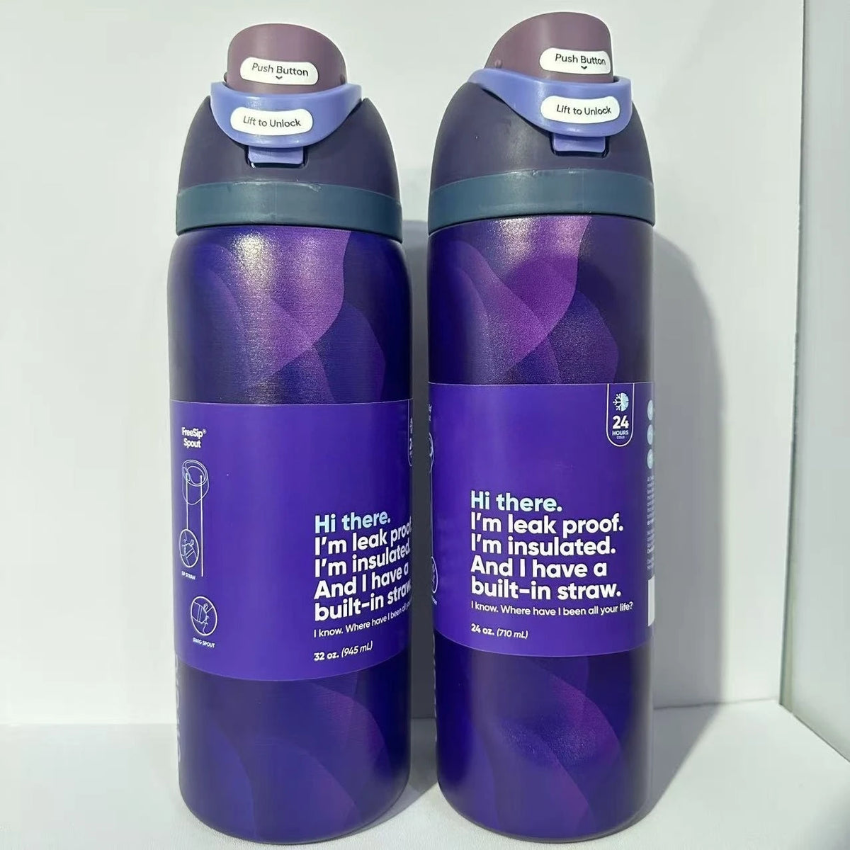 A purple stainless steel vacuum insulated water bottle with a push button and straw attachment.
