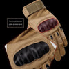 Close-up view of a tan tactical glove showing a forming protective plate at the hand bend.