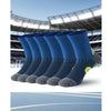 A pack of blue performance running socks with gray toe grips displayed against a blurred sports stadium background.