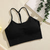 Black ribbed crop top sports bra for yoga and fitness displayed on a light background.