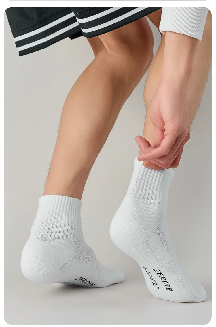 A close-up of a person putting on white breathable sports performance socks