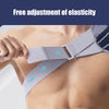A hand adjusts a gray elastic shoulder support brace on a person's upper back.
