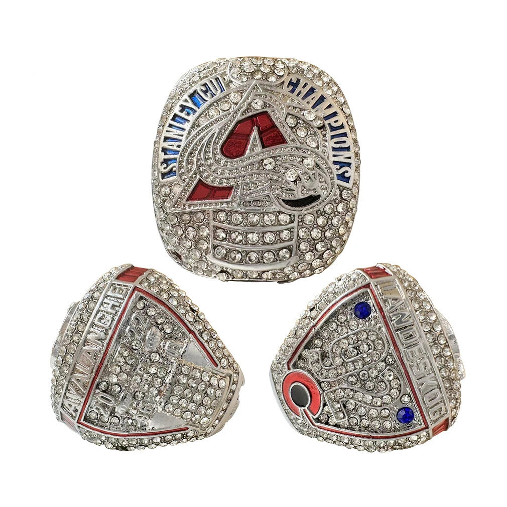 A pair of intricate championship couple rings featuring diamond and enamel designs.