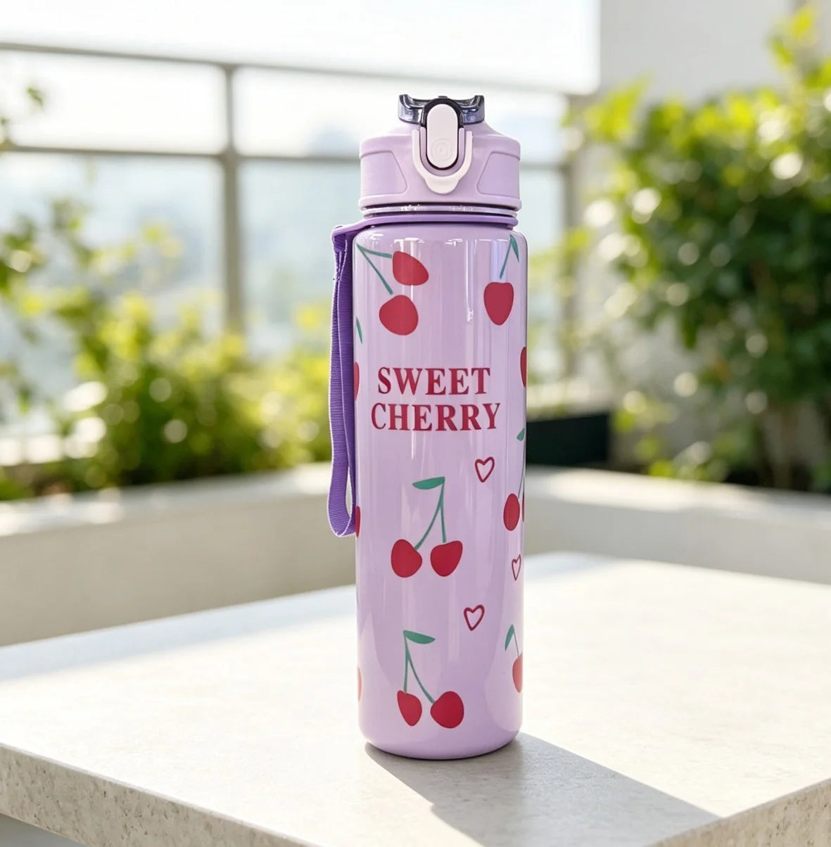 A purple reusable water bottle with a strawberry design sitting on a white surface.