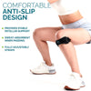 A person wearing a black anti-slip knee strap on their leg while standing and wearing athletic shoes.