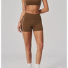 A woman models a brown two-piece yoga and sports tracksuit set featuring a cropped top and shorts.