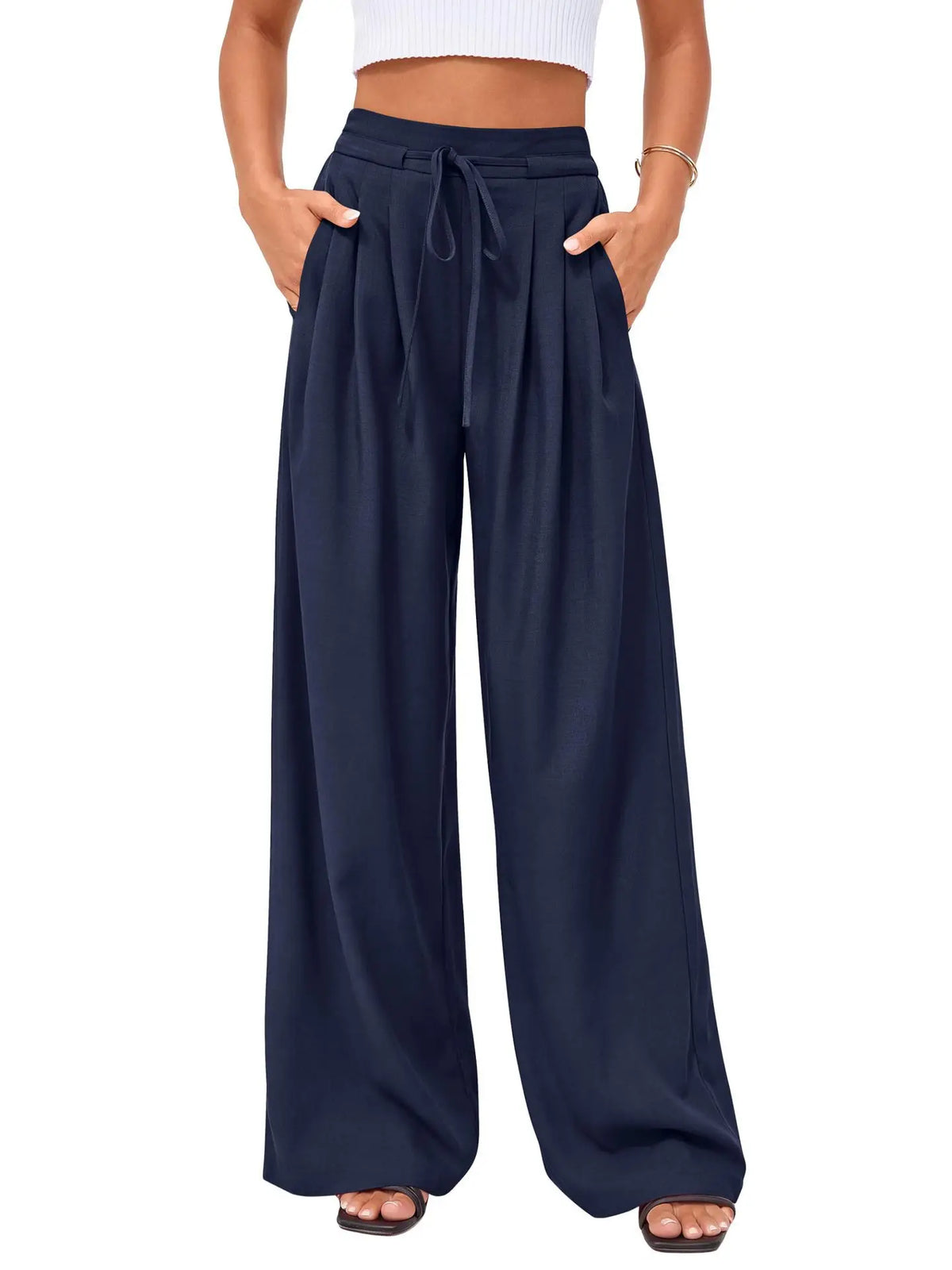 Navy blue flowy high waist drawstring wide leg pants worn by a person.