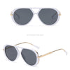 White and black sunglasses with gold accents shown in a studio shot.