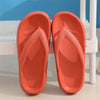 Pair of bright orange comfort platform flip flops resting on a white surface.