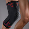 A black compression knee support sleeve worn on a person's leg.
