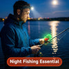 A man is using a clip-on fishing bite alarm with an LED flash while fishing at night.