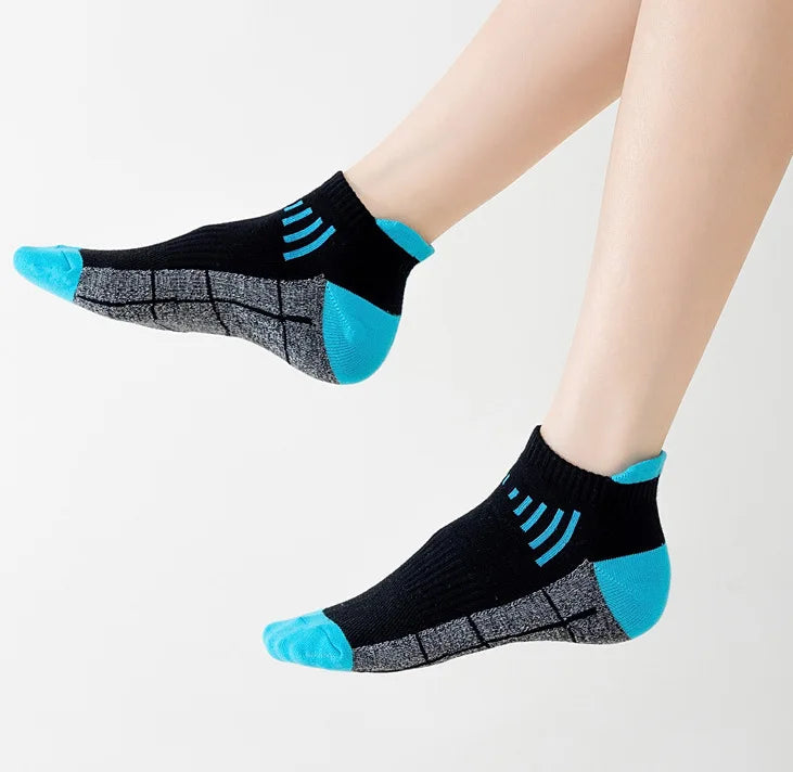 A close-up of a pair of black knit sports socks with bright blue accents and a textured gray pattern.