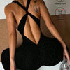 A woman wearing a black leopard print seamless yoga jumpsuit, shown from the back.