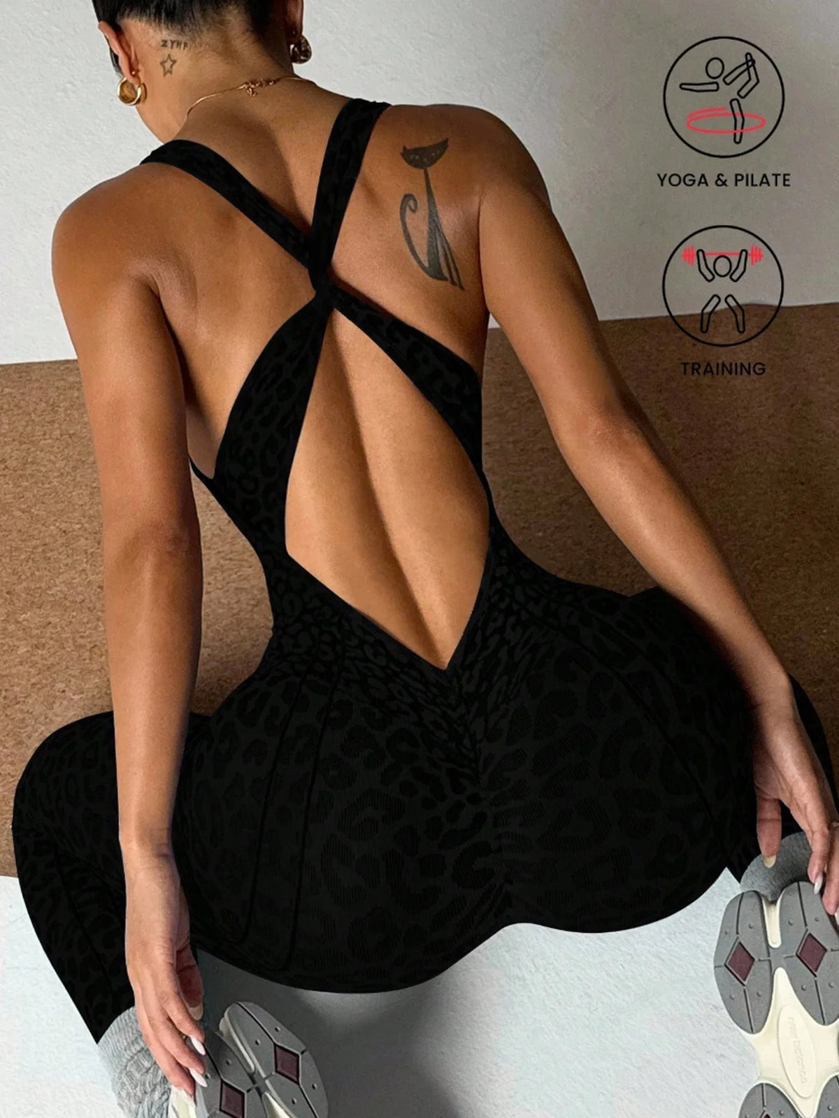 A woman wearing a black leopard print seamless yoga jumpsuit, shown from the back.