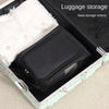 A black shoe carrier bag with a white fluffy lining is shown inside an open suitcase for luggage storage.