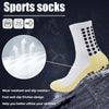 A close-up of a white sports sock with black dots and yellow accents, designed for grip and slip resistance.