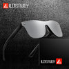 A pair of silver frameless sports sunglasses resting above a black box, set against a dark textured background.