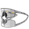 A pair of clear photochromic sports sunglasses with dark frames and orange accents.