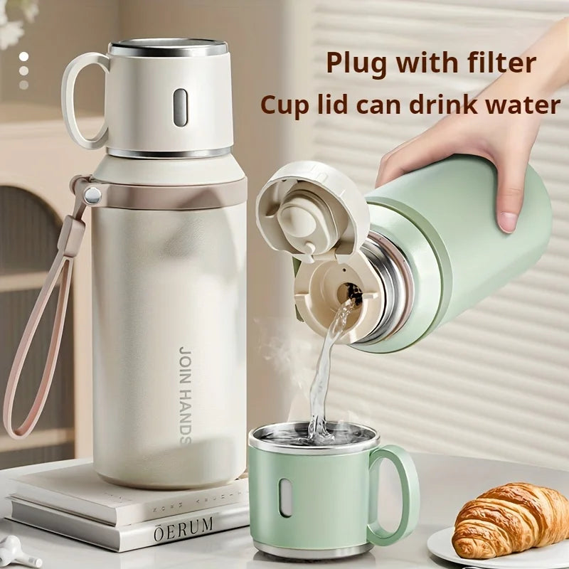 A hand is shown plugging a filter into a stainless steel insulated water bottle to drink water.