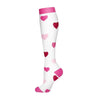 A pair of white compression socks with pink heart patterns.