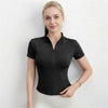 A woman models a black lightweight slim fit sports yoga top with a zip collar and short sleeves.