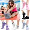A collection of non-slip grip socks in various colors and styles for yoga and pilates.