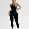 A model wearing a black seamless yoga jumpsuit with a white stripe detail.