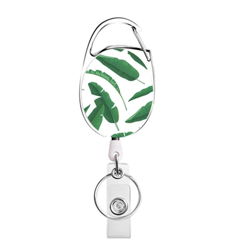 Silver retractable ID badge reel keychain with a green leaf design